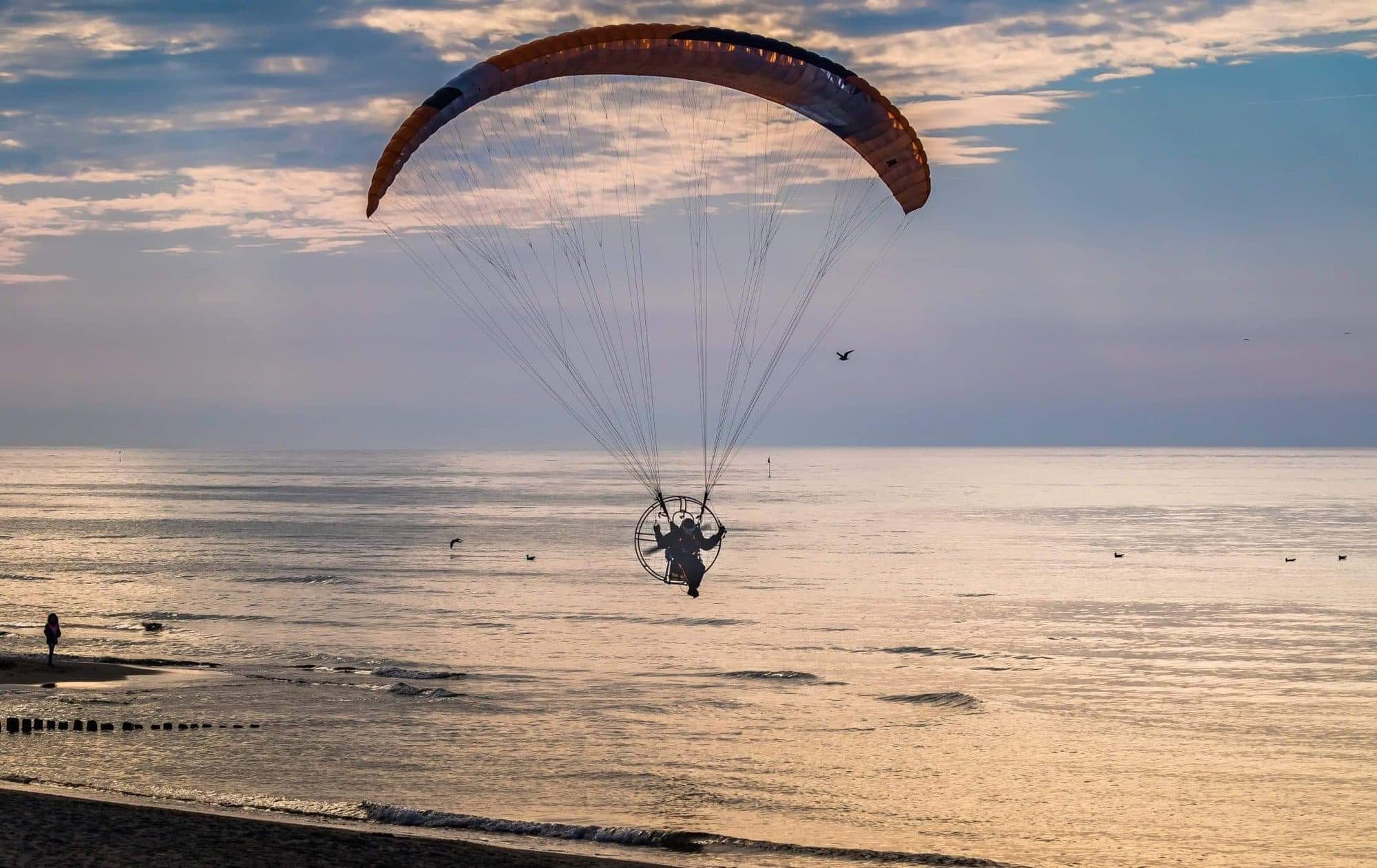 Powered paraglider over the beach in Sarbinowo